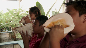 Children at the Nawahi Hawaiian Immersion School sound conch shells to signal the start of the school day